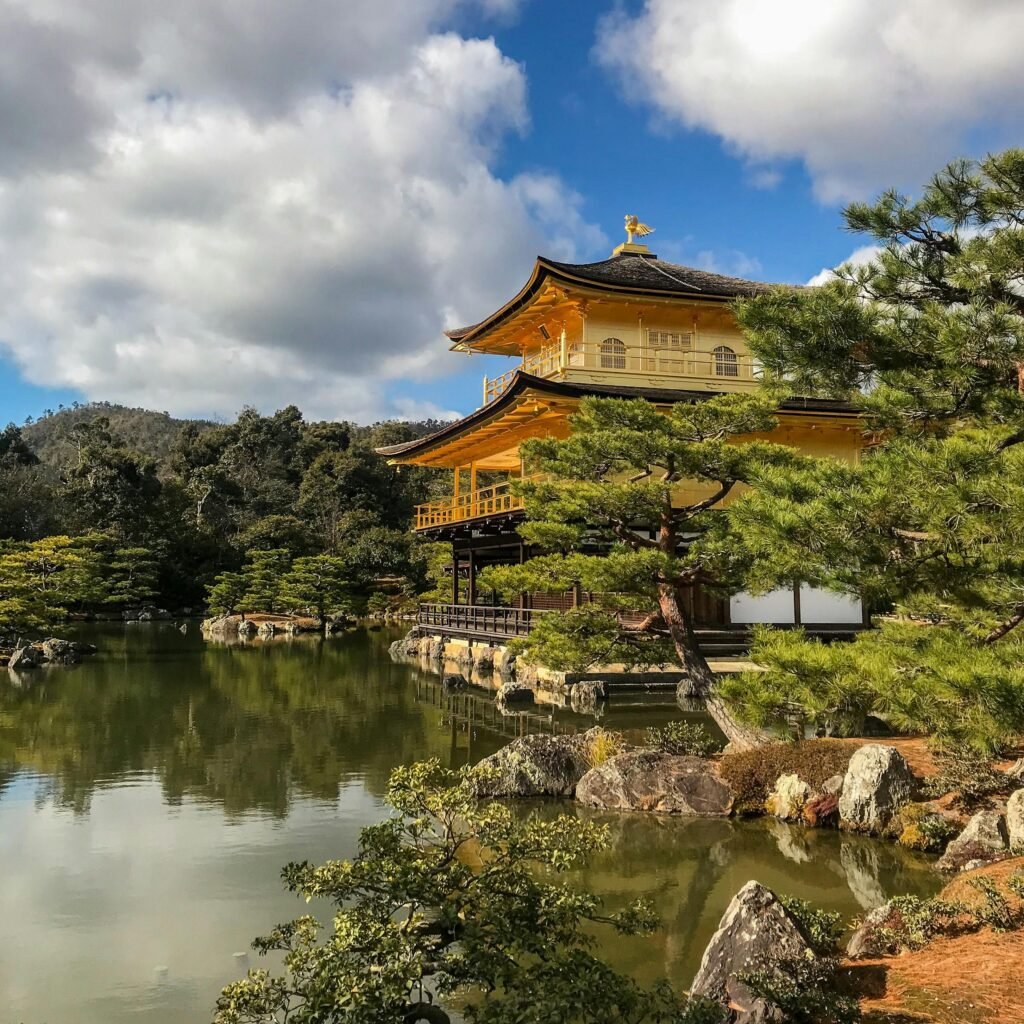 A stunning view of the Golden Pavilion in Kyoto, Japan reflecting in a serene pond.