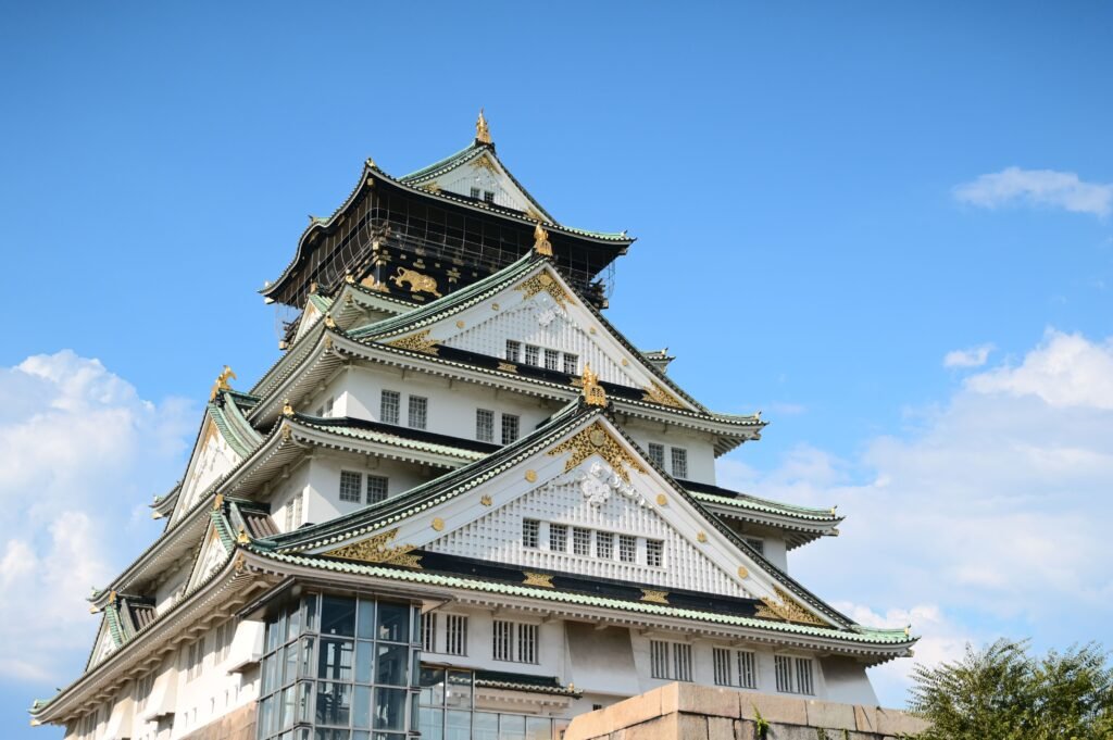 Stunning view of Osaka Castle in Japan against a clear blue sky, highlighting its historical architecture.