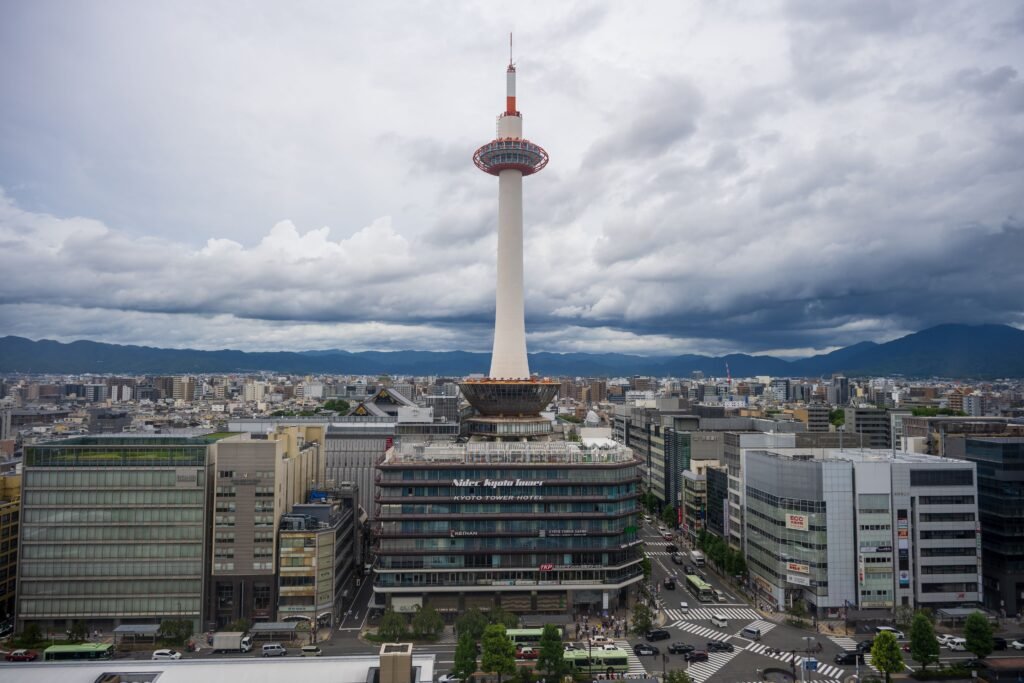 Explore the iconic Kyoto Tower surrounded by scenic urban landscapes in the heart of Kyoto, Japan.