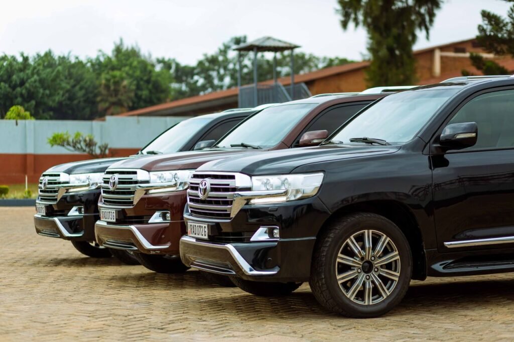 Row of Toyota Land Cruisers parked outdoors, showcasing automotive design.