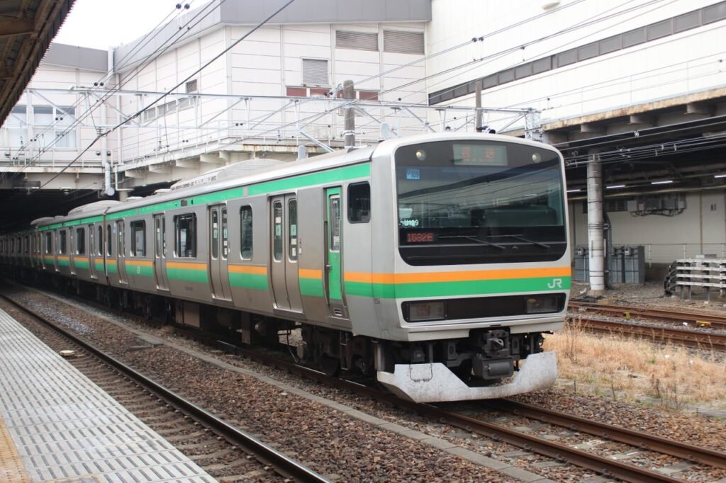 Commuter train at Utsunomiya Station, highlighting Japan's efficient rail system.