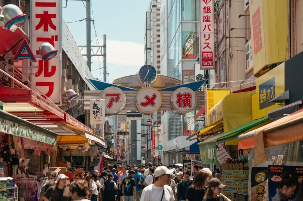 Bustling Ueno street market in Tokyo filled with vibrant signs and diverse crowd.