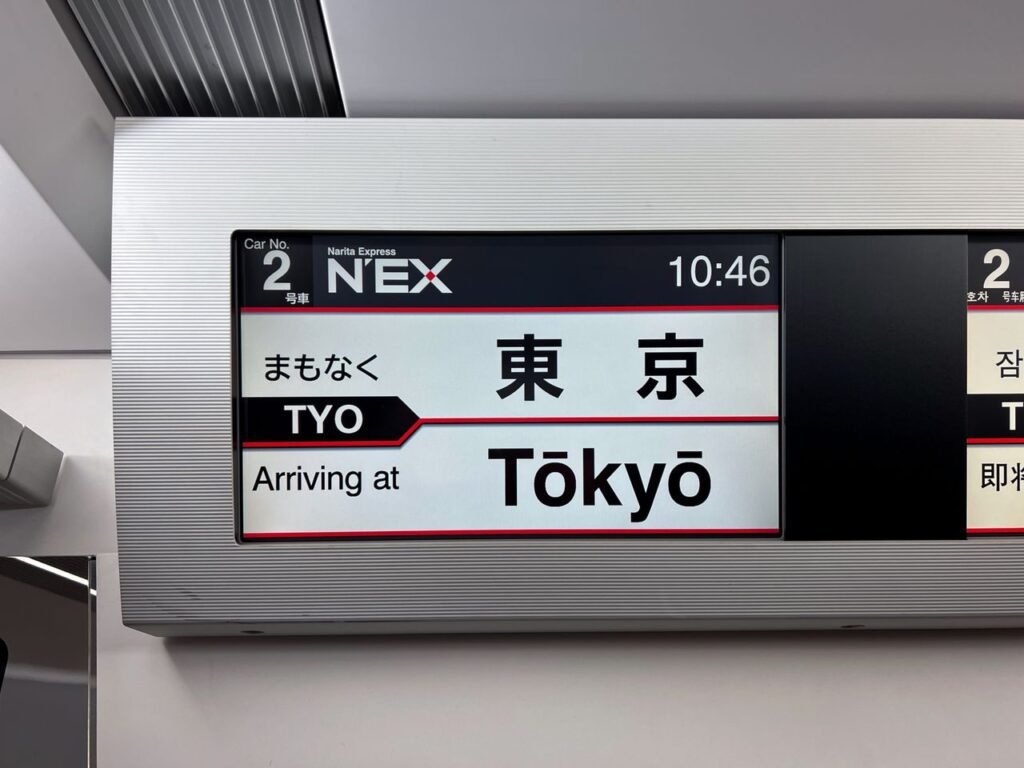 Close-up of Narita Express display showing arrival at Tokyo station.