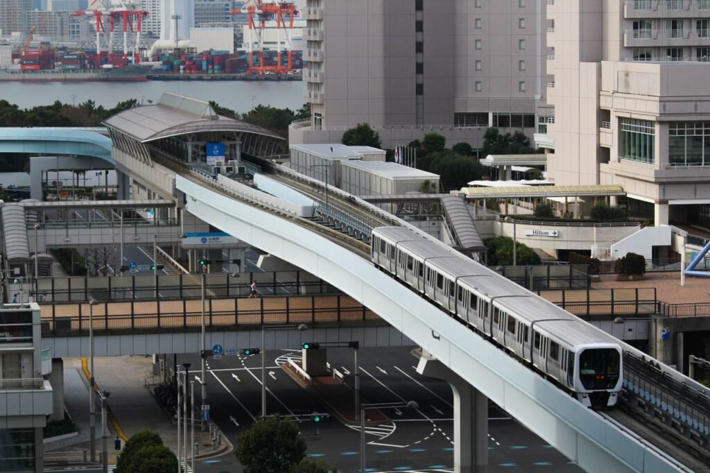 Stunning aerial view of Tokyo monorail passing through a modern urban landscape with city buildings.