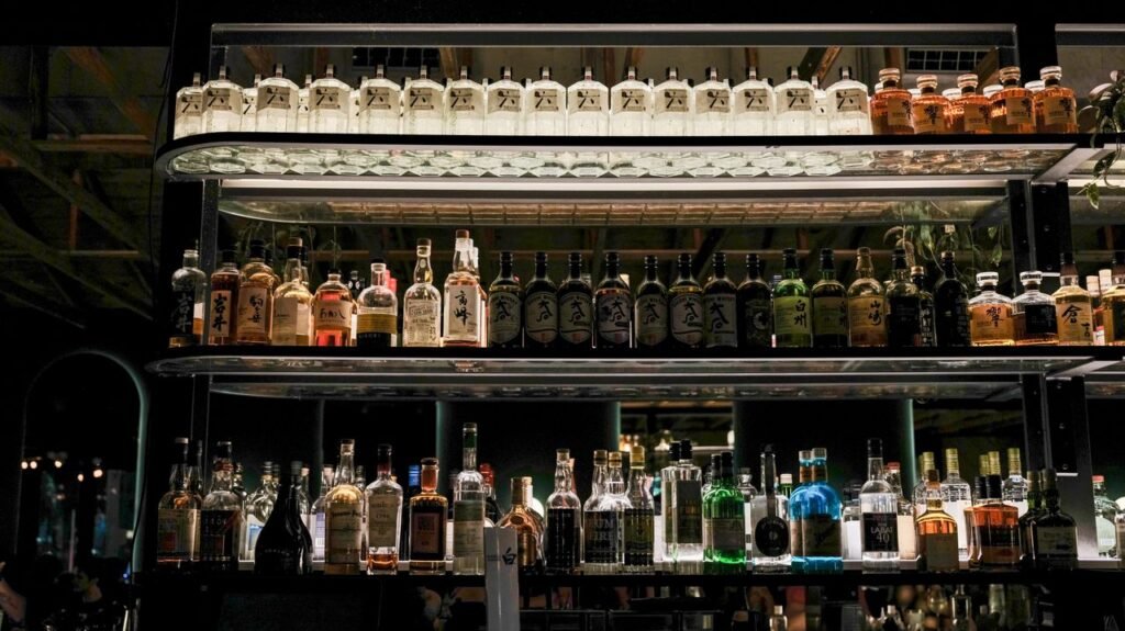 Stylish bar with shelves of various Japanese liquors, creating a chic ambiance.